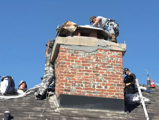 Orange Chimney Sweep installing a custom chimney crown in Orange, CT
